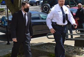 Colin Hugh Tweedie, 30, left, was escorted Friday into the Sydney Justice Centre by Cape Breton County Sheriff Sheldon Whitty where he was placed on probation for 18 months for obstructing a police officer. The charge was filed in connection with a motor vehicle accident that claimed the life of a 10-year-old girl in 2019. CAPE BRETON POST PHOTO