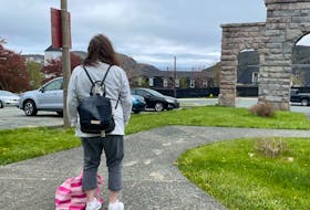 Cindy Lee looks out over downtown St. John’s. Her backpack and bag contain her few belongings, mostly toiletries so that she can get cleaned up in a public washroom. -Juanita Mercer/SaltWire Network