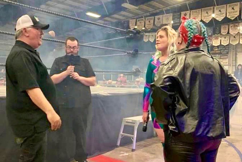 Doug Parker, left, talks to Karma Rayne, centre, and Vixen during a recent IPW event in New Brunswick. Parker, who founded Island Pro Wrestling, says the tribute show to Joey Arsenault on June 4 is about showing Joey’s family that the community still thinks about him.