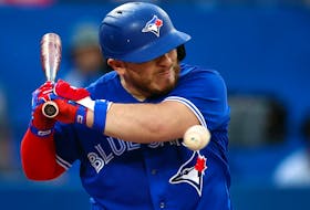 Alejandro Kirk #30 of the Toronto Blue Jays is hit by a pitch in the third inning  against the Boston Red Sox at Rogers Centre on Wednesday. 
