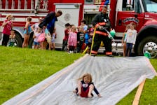 Windsor firefighters Matt Dunfield and Joe Britten (pictured) helped keep kids cool during the Teddy Bear Jamboree in Falmouth June 25. It’s become tradition that area firefighters provide a free soapy slide for youth to enjoy at the festival.