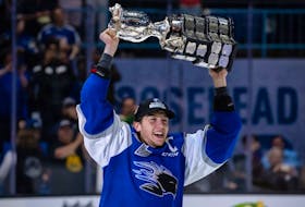 Saint John Sea Dogs captain Vincent Sevigny lifts the Memorial Cup trophy after a 6-3 win against the Hamilton Bulldogs in the final at Harbour Station arena in Saint John, NB, on June 29, 2022. 