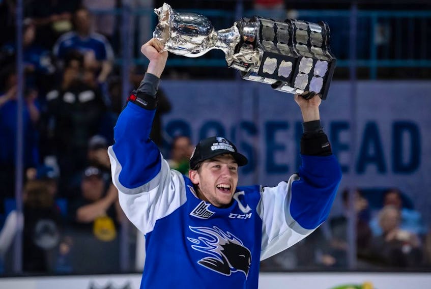 Saint John Sea Dogs captain Vincent Sevigny lifts the Memorial Cup trophy after a 6-3 win against the Hamilton Bulldogs in the final at Harbour Station arena in Saint John, NB, on June 29, 2022. 