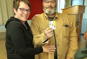 Annette Diewold, left, holds up the elusive ace of spades with her husband Russell McKenna at the Winsloe Lion's Club on June 4. Diewold won more than $2.4 million in the North Shore Chase the Ace lottery. - Facebook photo.