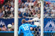  Vancouver Whitecaps’ Brian White, back right, is stopped by Real Salt Lake goalkeeper Zac MacMath during the first half of an MLS soccer game in Vancouver, on Saturday, June 4, 2022.