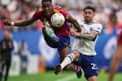 Real Salt Lake's Sergio Cordova, left, and Vancouver Whitecaps' Erik Godoy vie for the ball during the first half of an MLS soccer game in Vancouver, on Saturday, June 4, 2022.