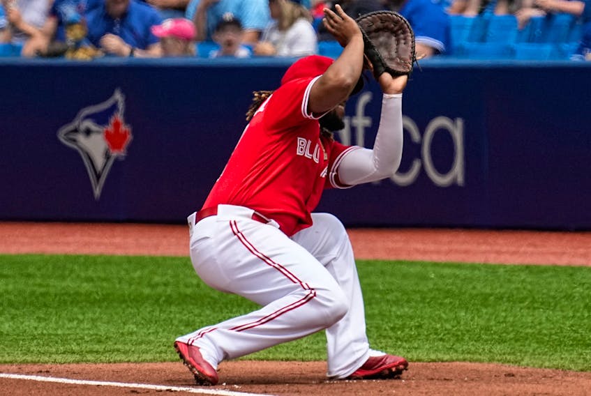 Blue Jays first baseman Vladimir Guerrero Jr. ducks out of the way after losing sight of high pop foul in the sun hit by Twins’ Jose Miranda during the first inning yesterday at the Rogers Centre. Given another chance, Miranda then singled home the Twins’ second run of the inning.  