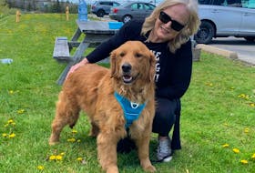 Gina Wells poses with her golden retriever Koda shortly after picking him up at Halifax Stanfield International Airport on May 20. Koda was likely destined for the dinner plate if he wasn't adopted through China Rescue Dogs. Contributed/Gina Wells