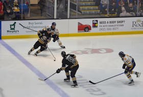 Charlottetown Islanders forward Xavier Simoneau, 81, is about to pass the puck to defenceman Lukas Cormier, 51, during Game 2 of the Quebec Major Junior Hockey League President Cup final at Eastlink Centre on June 5. Defending on the play are the Shawinigan Cataractes’ Zachary Massicotte, 89, and Pierrick Dubé, 92. The Cataractes take a 2-0 lead in the best-of-seven series into Game 3 in Shawinigan, Que., on June 8. Jason Simmonds • The Guardian