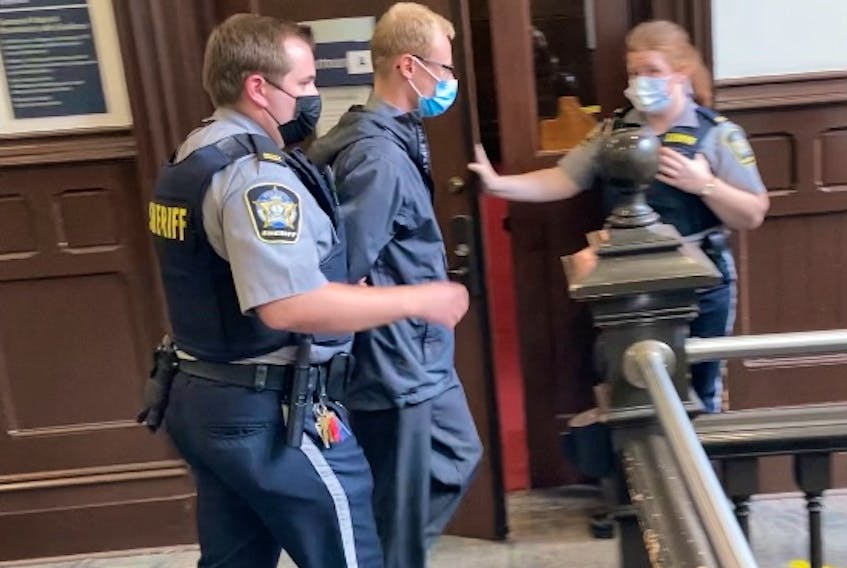 Cody Brian MacLean Gallie is escorted out of Halifax provincial court to begin serving a two-year prison sentence for aggravated assault.
