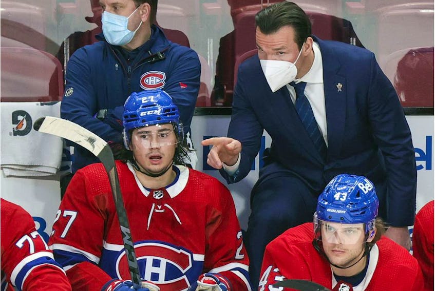 Canadiens assistant coach Luke Richardson has a conversation with defenceman Alexander Romanov as teammate Kale Clague looks on during second period against the Washington Capitals in Montreal on Feb. 10, 2022.   