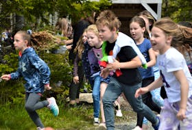 Wearing his hoodie like a cape, Ben Spencer, second from right, rushes to break from the pack of fellow Riverside School students during a run on Monday done as a practice for the Doctors Nova Scotia Youth Run on June 12. NICOLE SULLIVAN/CAPE BRETON POST