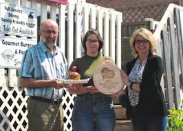 P.E.I. Federation of Agriculture president Ron Maynard, left, Backwoods Burger owner Erica Wagner and Fresh Media president and creative director Melody Dover with the award for P.E.I.'s most loved burger.