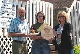 P.E.I. Federation of Agriculture president Ron Maynard, left, Backwoods Burger owner Erica Wagner and Fresh Media president and creative director Melody Dover with the award for P.E.I.'s most loved burger.
