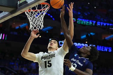Zach Edey #15 of the Purdue Boilermakers and Clarence Rupert #12 of the St. Peter's Peacocks jump for the ball in the first half of the game in the Sweet Sixteen round of the 2022 NCAA Men's Basketball Tournament at Wells Fargo Center on March 25, 2022 in Philadelphia, Pennsylvania.