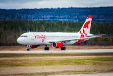 An Air Canada Rouge plane is seen on the runway and the Deer Lake Regional Airport in Deer Lake. The airline is reducing the number of flights at the airport as it tries to deal with staffing and other issues. - Contributed