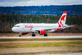 An Air Canada Rouge plan is seen on the runaway and the Deer Lake Regional Airport in Deer Lake. The airline is reducing the number of flights at the airport as it tries to deal with staffing and other issues. - Contributed