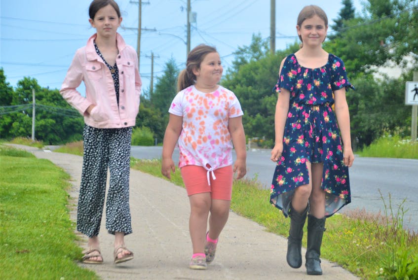 From left, Coxheath Elementary students Laurie McCarron, 8, Georgia Smith, 5, and Alani Bachus, 9, walk to school. The three friends live near each other and decided to walk after two of them missed the bus on the last day. NICOLE SULLIVAN/CAPE BRETON POST  From left, Coxheath Elementary students Laurie McCarron, 8, Georgia Smith, 5, and Alani Bachus, 9, walk to school. The three friends live near each other and decided to walk after two of them missed the bus on the last day. NICOLE SULLIVAN/CAPE BRETON POST