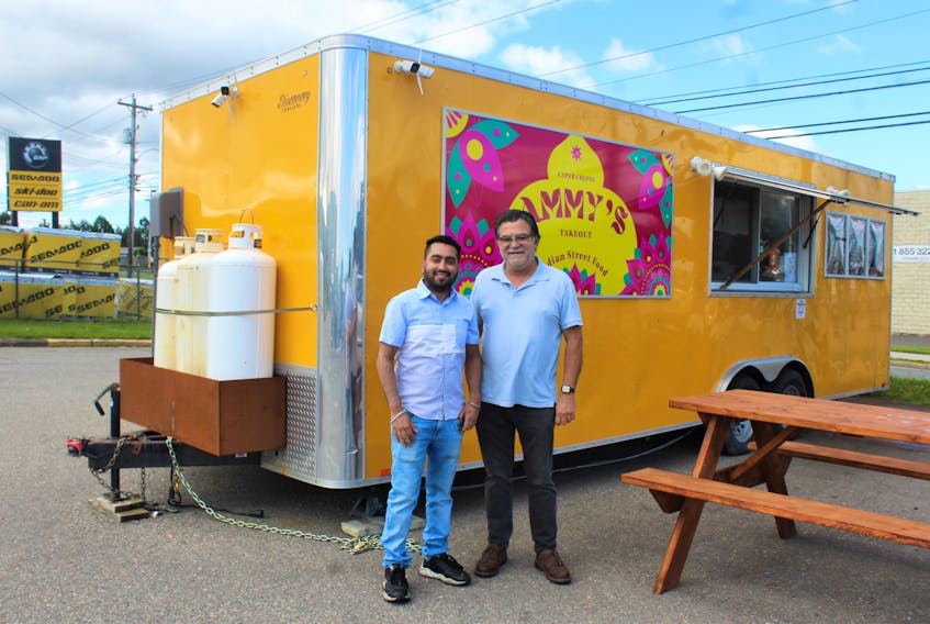 Ammy Singh, left, and Sanjive Kochhar stand outside Ammy's Food Truck in Sydney. The men opened the Indian street food truck on Feb. 1. NICOLE SULLIVAN / CAPE BRETON POST