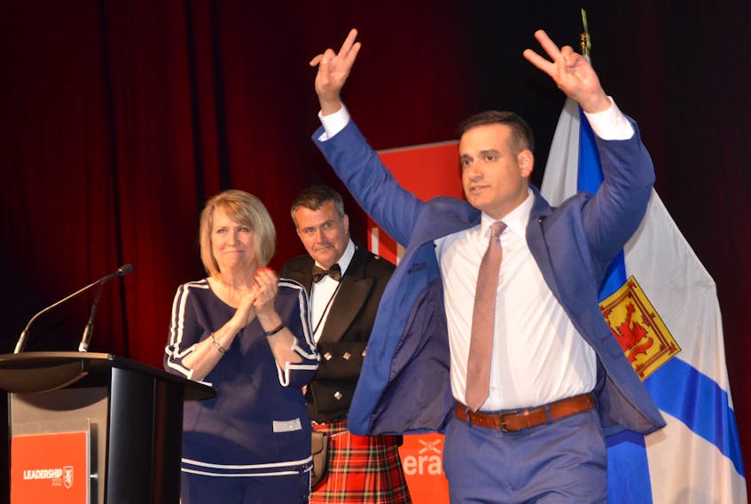 Yarmouth MLA Zach Churchill raises his arms in victory on Saturday, July 9, 2022, as he takes the stage after it was announced at the Halifax Convention Centre that he won the party leadership vote. Leadership campaign co-chairs Dr. John Gillis and MLA Kelly Regan look on. FRANCIS CAMPBELL/THE CHRONICLE HERALD