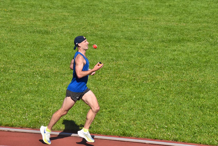 Joggler Michael Bergeron attempts to set a Guinness World Record time for joggling 10 kilometres at the UPEI track July 10. - Alison Jenkins • The Guardian