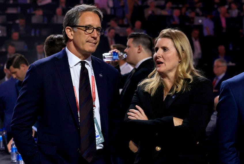 Maple Leafs president Brendan Shanahan (left) and assistant general manager Hayley Wickenheiser talk prior to Round 1 of the 2022 NHL Draft at the Bell Centre on July 7  in Montreal.