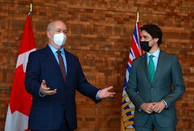 Prime Minister Justin Trudeau meets with B.C. Premier John Horgan during a break from the GLOBE Forum at the Convention Centre in Vancouver on Tuesday, March 29, 2022.