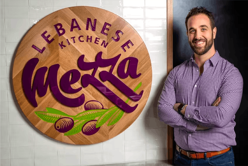 Peter Nahas, Vice President of Business Development and Franchising at Mezza, stands in one of the restaurant’s new locations. PHOTO CREDIT: Contributed