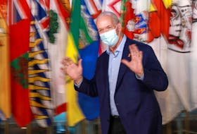 Premier John Horgan gestures during a break from the summer meeting of the Canada's premiers in Victoria on Monday.