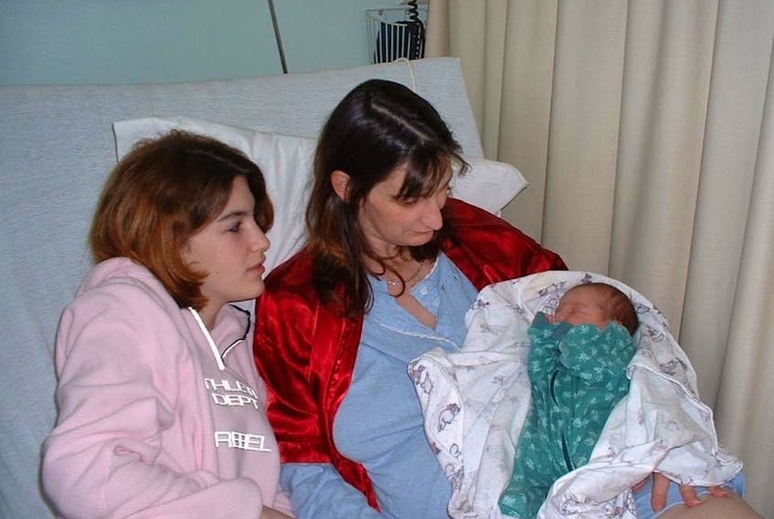 Erica Wicks as a newborn, with her half-sister Alicia and mother Lisa Southern.