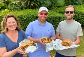 From left, Erin Sulley, her brother, Ryan Sulley and friend Nate Atcheson, enjoying a traditional Bermudian fish sandwich. Debra Kearsey photo