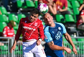 HFX Wanderers’ Peter Schaale, right, goes up a header against Jose Escalante during Canadian Premier League action on Thursday night in Calgary. – Canadian Premier League