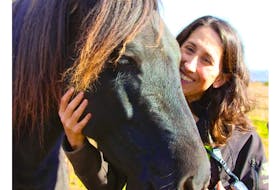 Caroline LeBlanc takes a moment to be with one of the horses from Serene View Ranch, a PTSD counselling centre in Alexandra, P.E.I. Contributed