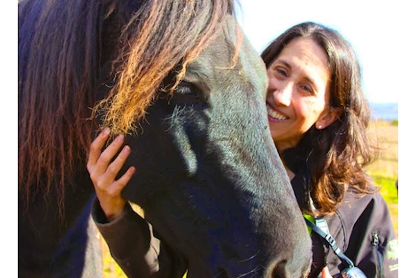 Caroline LeBlanc takes a moment to be with one of the horses from Serene View Ranch, a PTSD counselling centre in Alexandra, P.E.I. Contributed