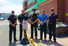 Cape Breton Regional Police partnered with CBRM Fire and Emergency Services for the fire lane awareness campaign in June. For roughly six weeks drivers have been given verbal warnings about the law forbidding vehicles from parking or stopping in the lane. Pictured here, from left, outside Sobeys on Prince Street are: Mark Jessome, Bruce MacDonald, Mitch Ellsworth, Chris March and Stephen MacKenzie. NICOLE SULLIVAN / CAPE BRETON POST