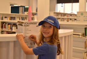 Elijah Lucas-Gay fills in a spot on his scavenger hunt at the Charlottetown Library Learning Centre July 18. Alison Jenkins • The Guardian