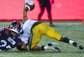 Edmonton Elks receiver Kenny Lawler (89) raises the ball in the air after scoring the winning touchdown on Montreal Alouettes defensive back Wesley Sutton (37) in Montreal on July 14, 2022.
