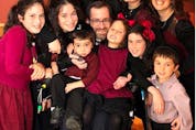  The Simes family in September 2013, more than three years after the highway rollover that left Rabbi Yehuda Simes a quadriplegic.