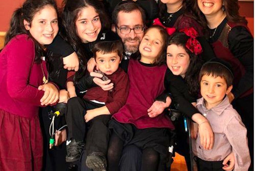  The Simes family in September 2013, more than three years after the highway rollover that left Rabbi Yehuda Simes a quadriplegic.