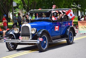 This parade participant was cruising in style July 1, blowing the car’s horn as they made their way through Hantsport.