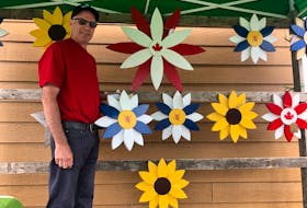 Woodworker Kevin Baillie’s taste in flowers runs to his own handcrafted sunflowers and those representing Nova Scotia and Canada. 