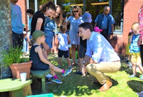 Four-year-old Ella MacDonald, left, talks with Prime Minister Justin Trudeau at the Early Learning Centre at Cape Breton University on Thursday. Trudeau was in Halifax in the morning to announce the $255 million in federal investment into clean energy in Nova Scotia. In the afternoon, Trudeau visited Cape Breton University where he first spoke with parents and children at the early childhood learning centre, then he attended a barbecue for university staff, faculty, students and their families. The Trudeau government has increased the Canada Child Benefit again, which went into effect on July 20. NICOLE SULLIVAN • CAPE BRETON POST
