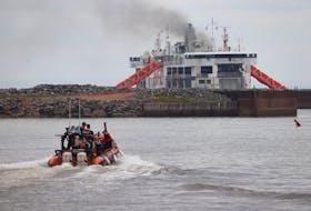 A vessel carrying emergency personnel heads out to a Northumberland Ferries Limited ferry that caught on fire outside the Wood Islands terminal on the morning of July 22. Other boats carried portable water tanks and hoses for crews to work on putting out the fire. Fire departments from Belfast, Vernon River, Murray Harbour, Central Kings and Crossroads helped EMS and RCMP to rescue passengers from the ferry. Halifax Joint Rescue Coordination Centre confirmed 182 passengers had been evacuated from the vessel. No injuries were reported when SaltWire spoke with Darcy MacPherson, Belfast's deputy fire chief.