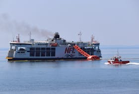 A Canadian Coast Guard boat heads out to the MV Holiday Island, a Northumberland Ferries Limited vessel that caught fire on July 22 and continued to burn on July 23. - Logan MacLean • The Guardian