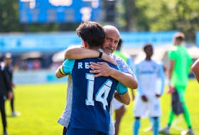 HFX Wanderers' Mateo Restrepo gets a hug from manager Stephen Hart after playing his final game with the Canadian Premier League team on Saturday at the Wanderers Grounds. Restrepo is leaving the sport to study at the prestigious Icahn School of Medicine at Mount Sinai in New York and pursue a medical career. - Trevor MacMIllan