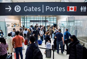Travellers crowd the security queue in the departures lounge at the start of the Victoria Day holiday long weekend at Toronto Pearson International Airport in Mississauga on May 20, 2022. 