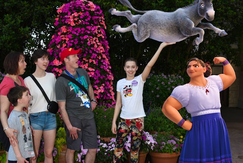 Molly Wadden, right, shows how strong she is to the feigned surprise of her family at Walt Disney World in Florida earlier this year. The trip was paid for by the Make-A-Wish foundation, one of the charities Molly raised money for in the spring. In the picture are, from left, brother Chase, mother Nadine, sister Larissa and father Jeff. CONTRIBUTED