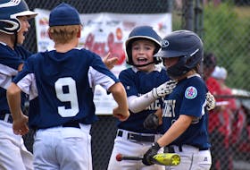 Sydney Major Sooners outfielder Brendan Young, middle, couldn’t help but smile as he celebrated with teammates after recording an inside the park home run during Nova Scotia Major Little League Championship action at Cameron Bowl in Glace Bay on Monday. Young and the Sooners defeated the Glace Bay McDonald’s Colonels 9-1 in the championship game, securing their spot in the Canadian Little League Championship next week in Alberta. JEREMY FRASER/CAPE BRETON POST.