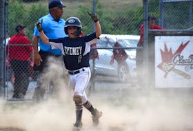Avery Johnston of the Sydney Major Sooners celebrates after crossing the plate during the Nova Scotia Major Little League championship game at Cameron Bowl in Glace Bay, Monday. Johnston was safe at home plate. JEREMY FRASER/CAPE BRETON POST.