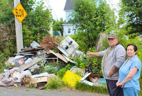 Glace Bay residents Francis Allison, left, and Ann Coombes show the garbage pile that had not been picked up — until Tuesday afternoon. IAN NATHANSON/CAPE BRETON POST